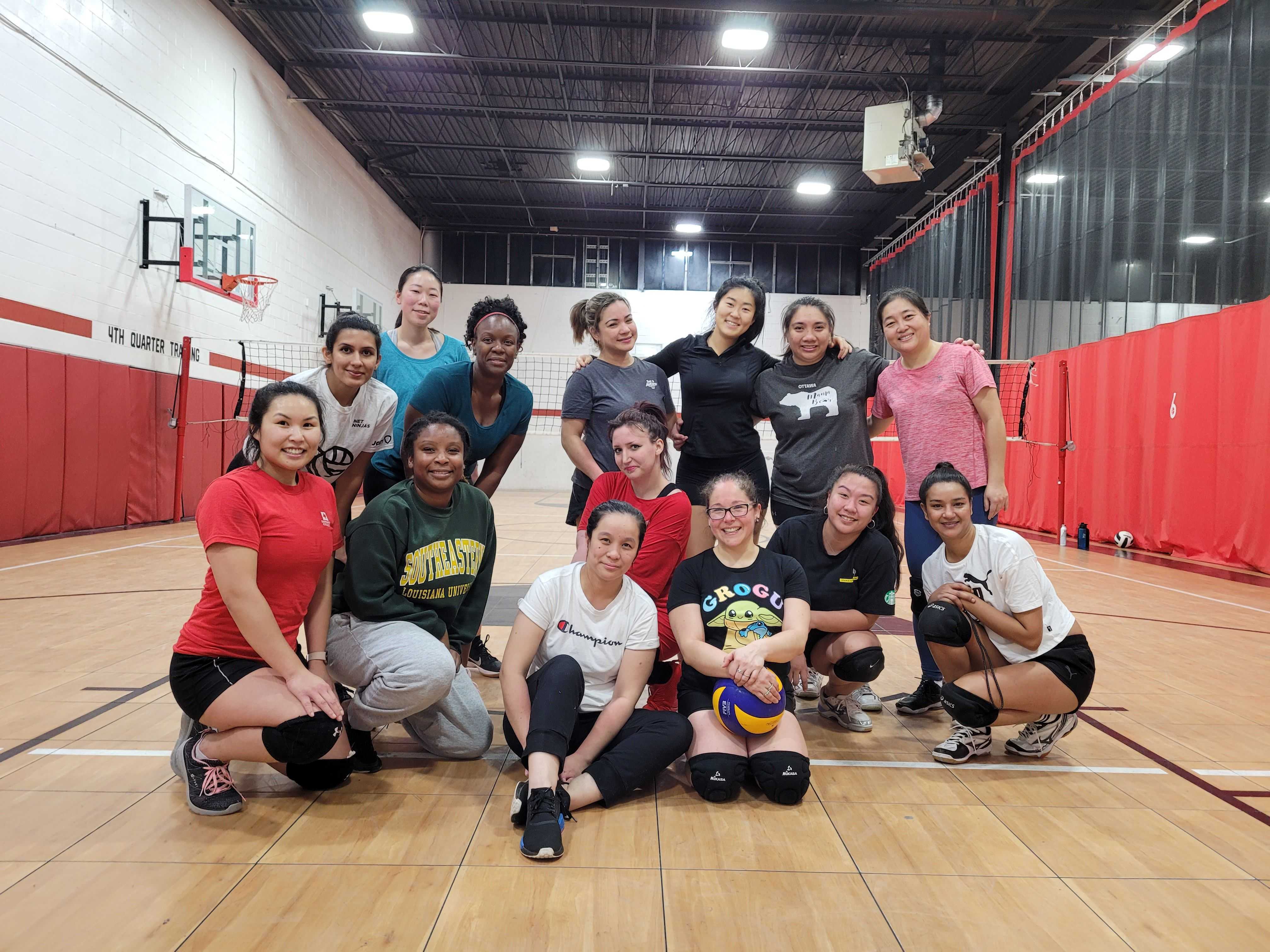 A women's only volleyball team after winning a game